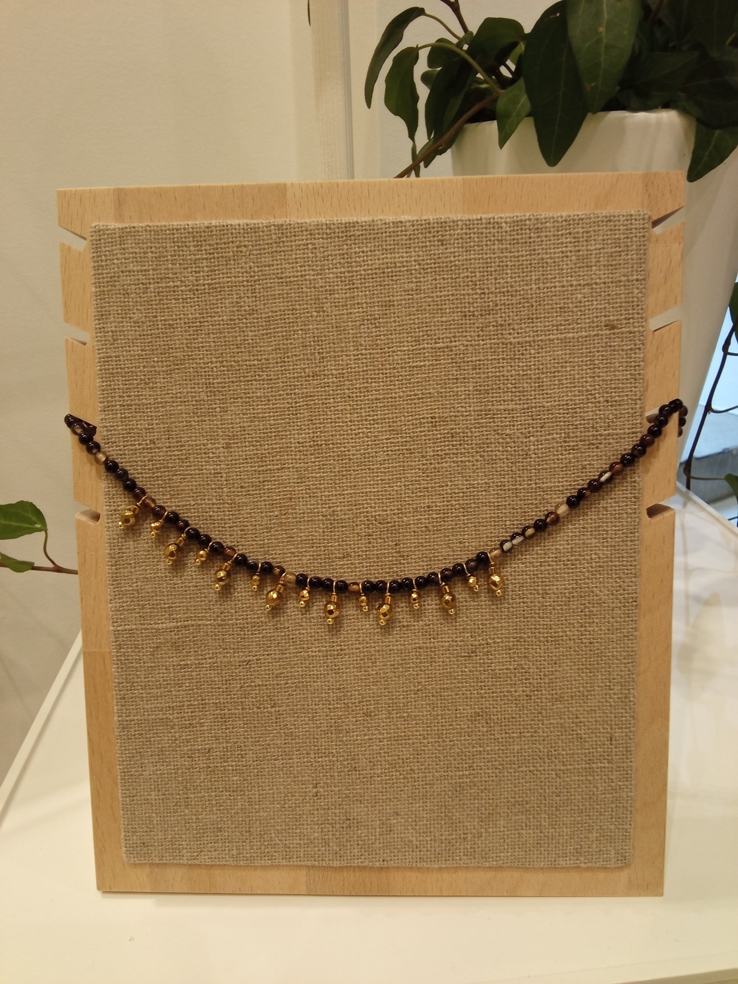 Beaded necklace with small gold charms