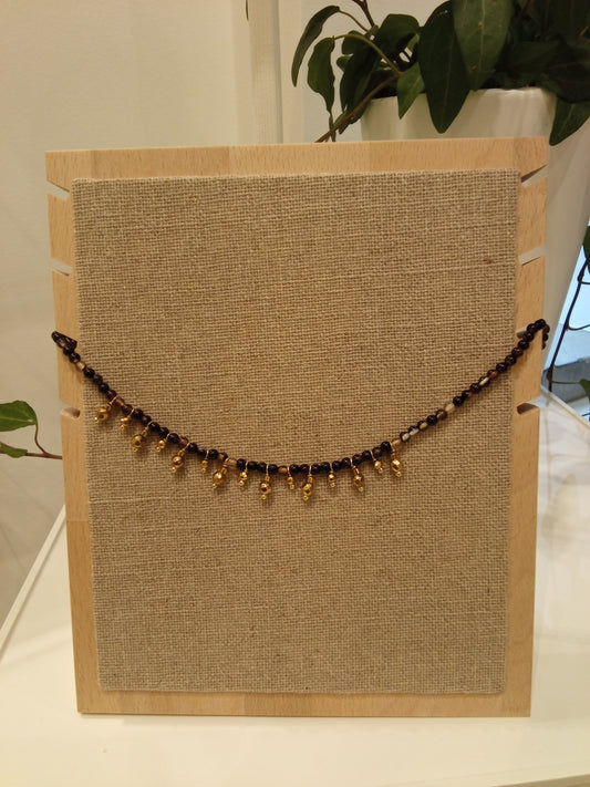 Beaded necklace with small gold charms