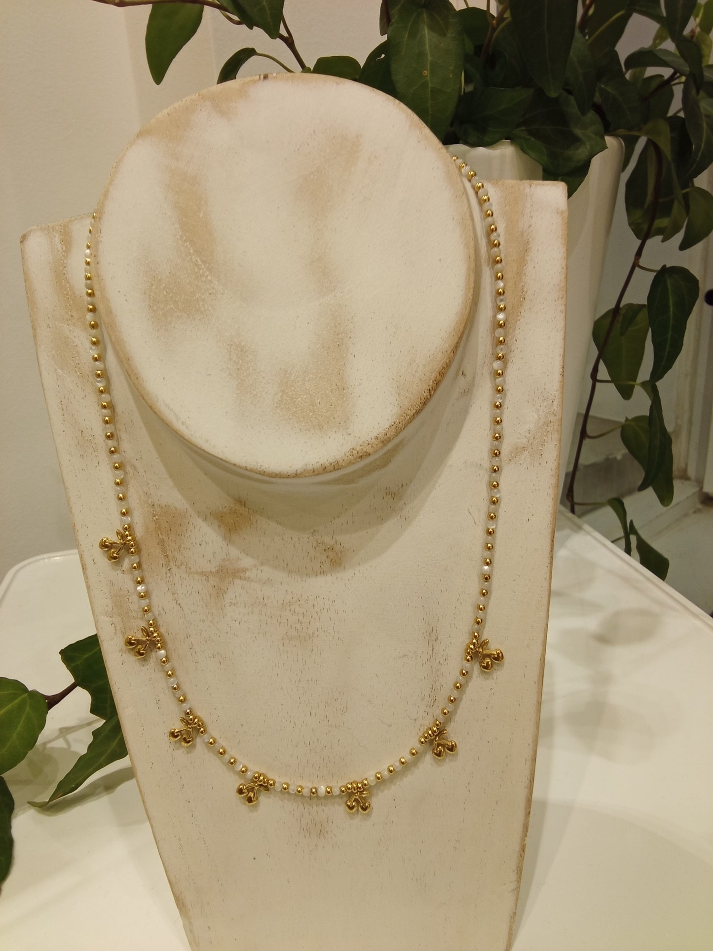White and gold beaded necklace with cherry pendants