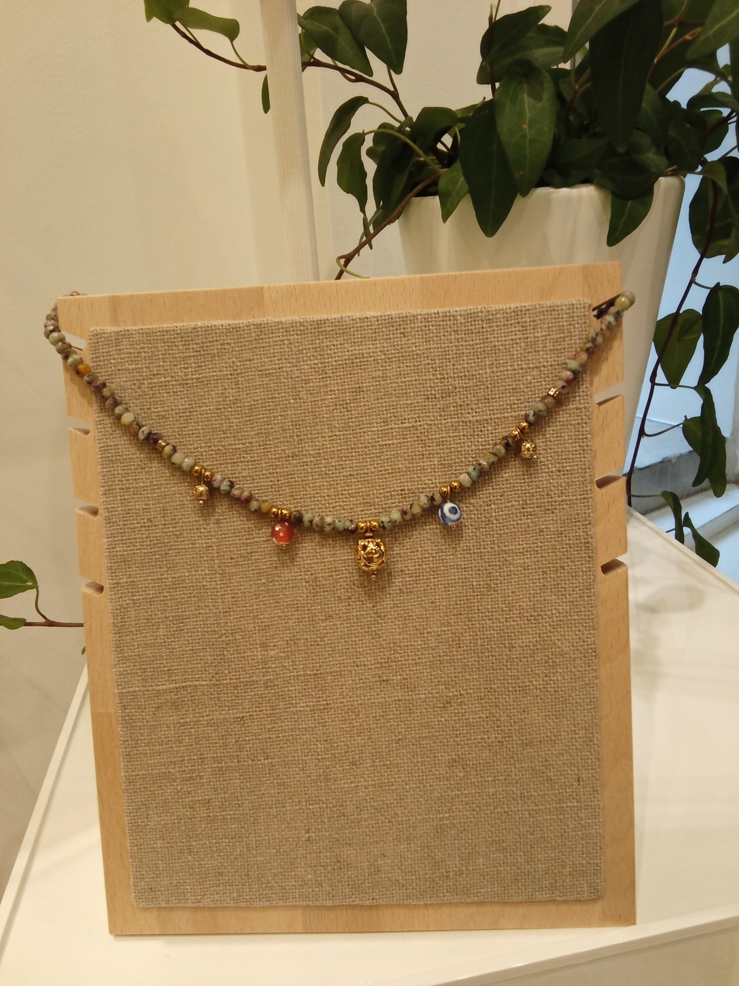 Beaded necklace with multiple ball charms