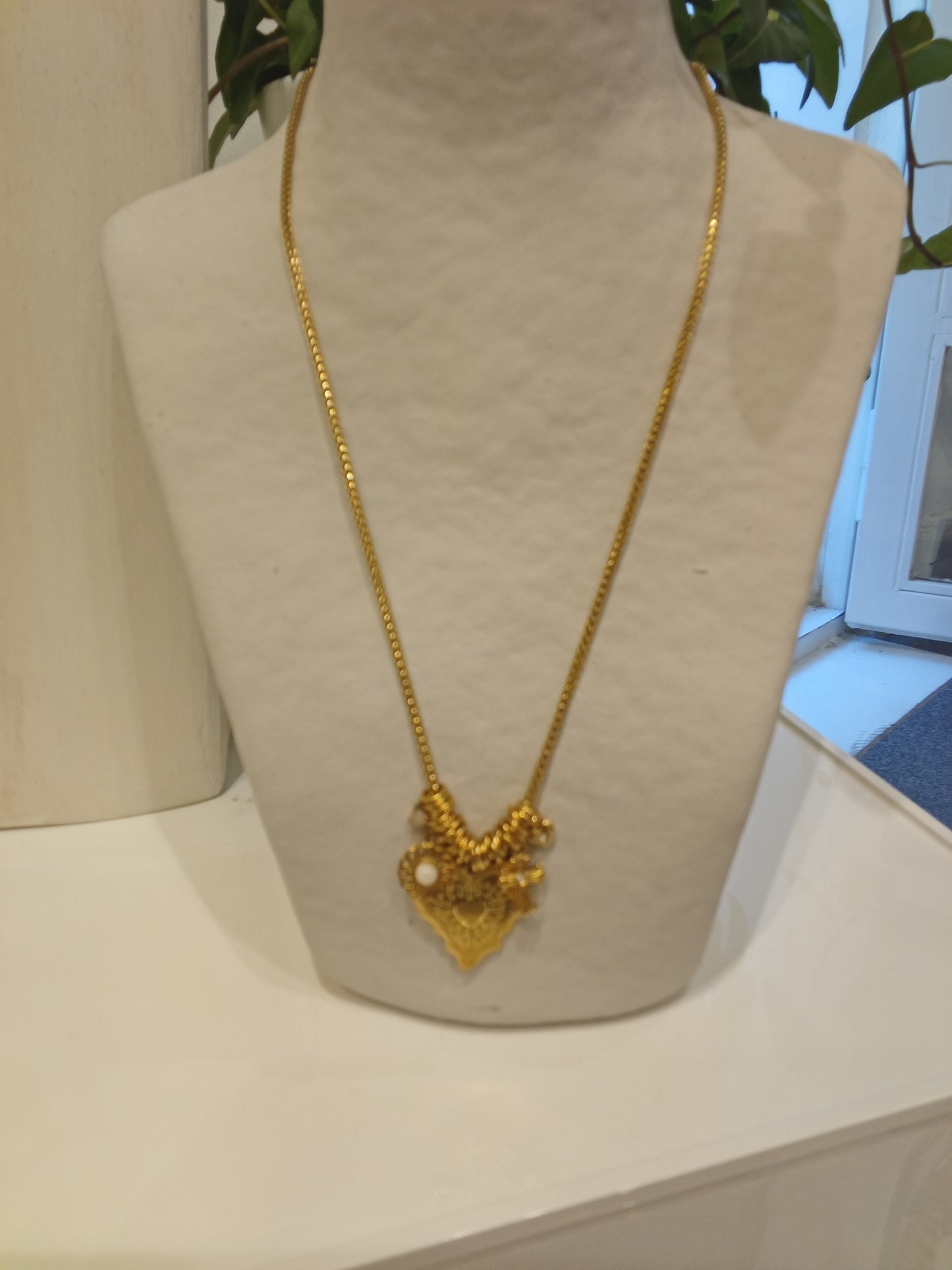 Necklace with a heart cross charm